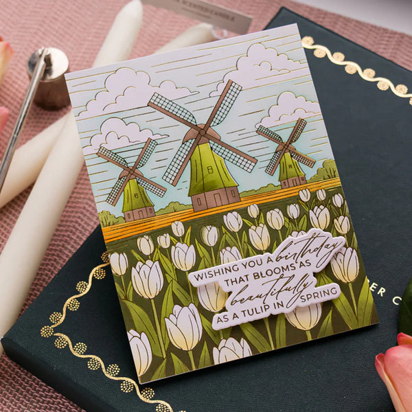 Greeting card with windmills and tulips on a black surface