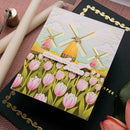 Notebook with windmill and tulip design on a pink surface