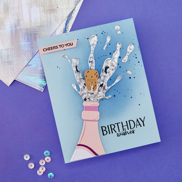 Birthday card with champagne bottle and cookie design on a purple background