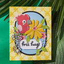 Colorful card with a parrot, flowers, and 'free hugs' text on a textured yellow background.