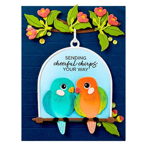 Decorative card with two colorful birds on a branch and floral elements.