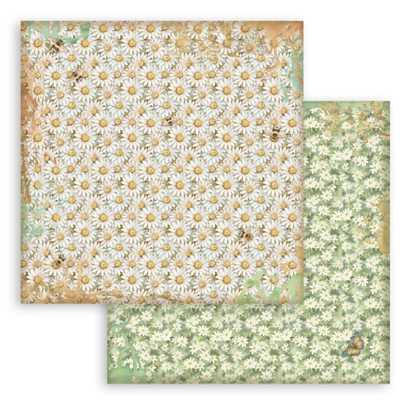 Two sheets of floral paper with daisy patterns on a white background