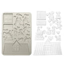 Silicone mold with farm animal and house shapes on a white background