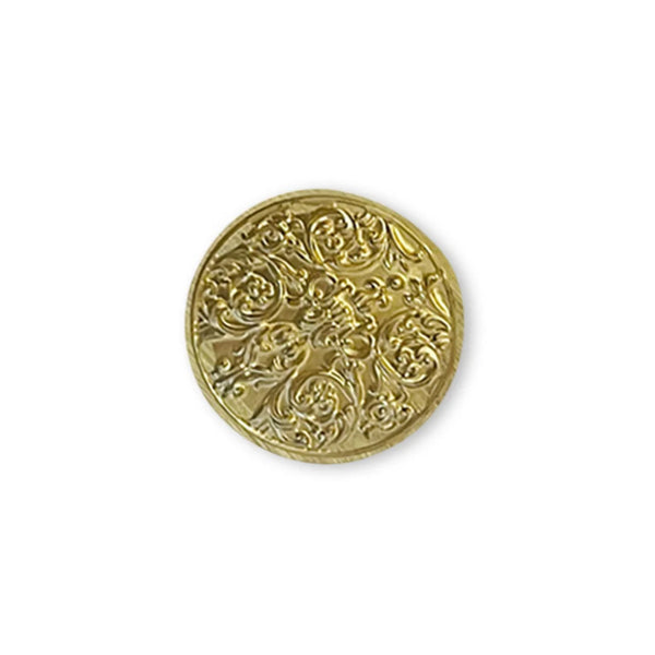 Decorative gold coin with intricate patterns on a white background