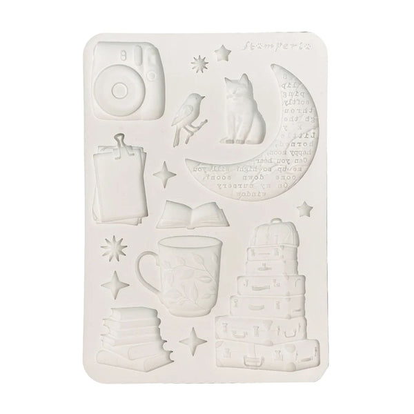 White embossing folder with various designs on a white background