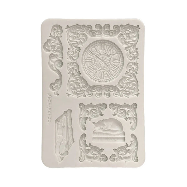 Decorative silicone mold with clock and musical instrument design on a white background