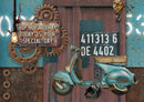 Decorative wall art with a scooter, gears, and text on a rustic background