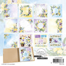 Collection of floral and nature-themed stationery items with a notebook and stamps on a light blue background.