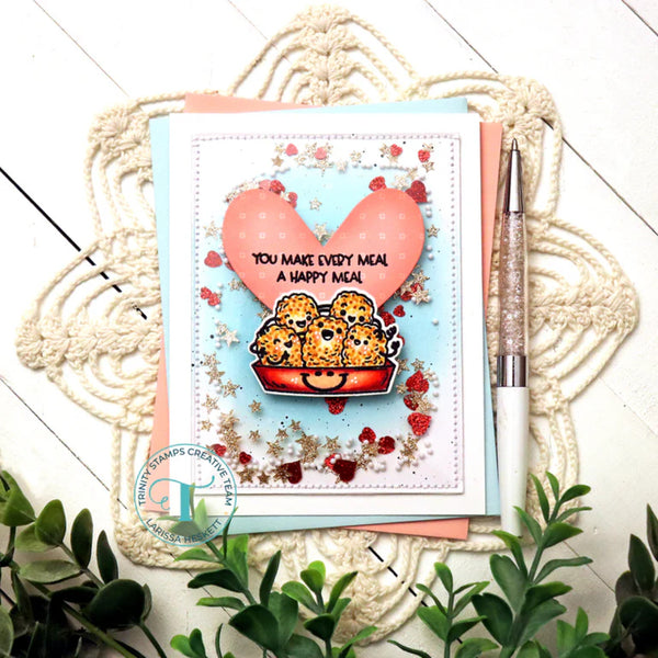Card with cartoon characters and heart design on a decorative surface with plants.