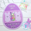 Easter card with bunnies and text on a purple background, featuring Trinity Stamps branding.