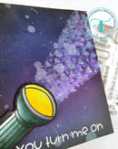 Card with a light bulb and purple hearts on a dark background, featuring 'Tombow Stamps Creative Team' logo.