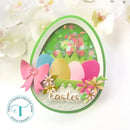 Easter-themed card with colorful eggs, flowers, and a bow on a white background.