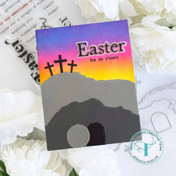 Easter card with 'he is risen' text and cross silhouette on a colorful background.