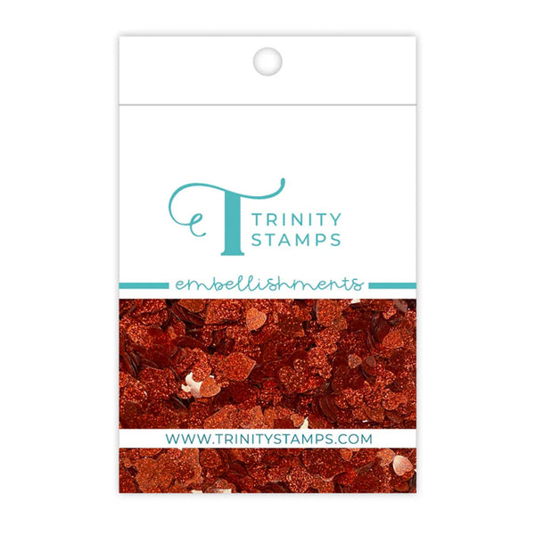Trinity Stamps embellishments packaging with a close-up of decorative elements on a white background.