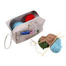 Knitting bag with yarn and tools on a white background
