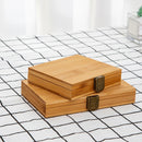 Two wooden boxes with metal latches on a checkered floor