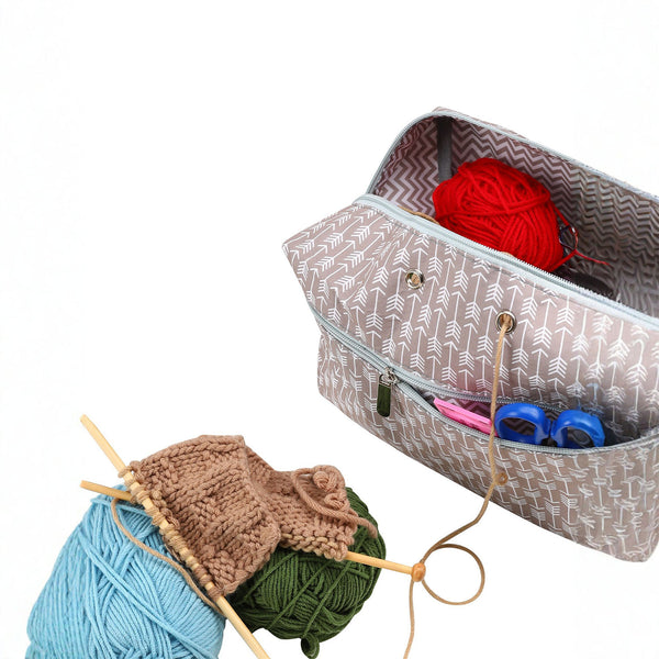 Knitting bag with yarn and tools on a white background