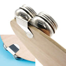 Close-up of a metal clip on a wooden surface with a white background