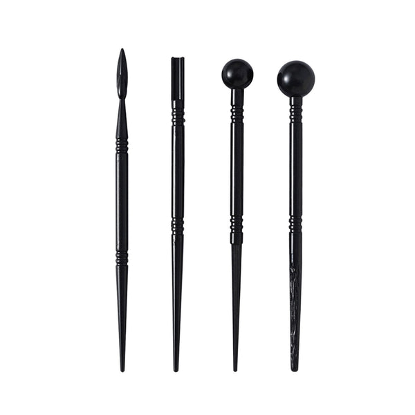 Set of four black hair styling tools on a white background