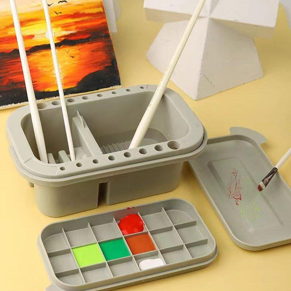 Gray art supply set with paintbrushes and color swatches on a yellow background