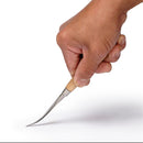 Hand holding a curved knife with a wooden handle on a white background