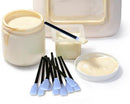 Ceramic containers with white substance, a brush, and blue-tipped applicators on a white background.