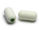 Two cylindrical white fishing floats with green eyes on a white background