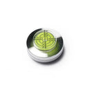 Small circular level with green bubble on a white background