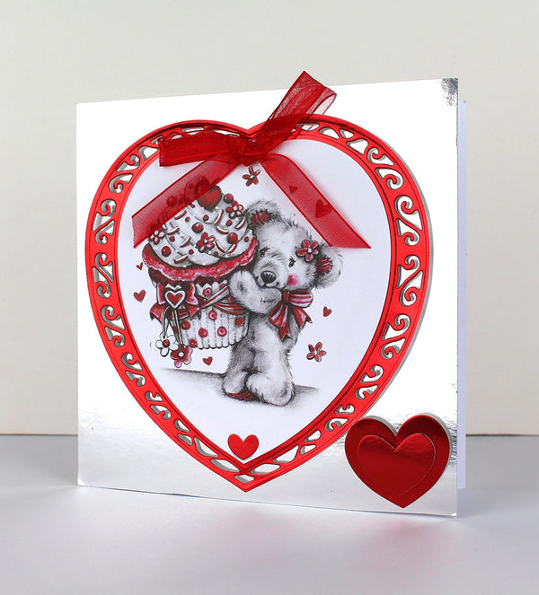 Greeting card with a heart-shaped design featuring a teddy bear and red ribbon on a white background.
