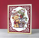 Card with a teddy bear holding gardening tools against a red background