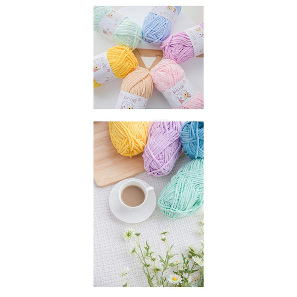 Pastel-colored yarn balls on a white surface with a cup of coffee and flowers.