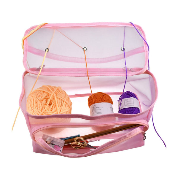 Pink mesh storage bag with yarn and knitting needles on a white background