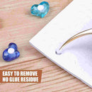 Blue heart-shaped glue dispensers on a wooden surface with text 'Easy to remove, no glue residue'.