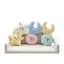 Set of colorful crocheted cushions shaped like a star, moon, and cloud on a white background.