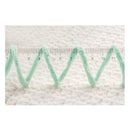 Green textured strip with a ruler on a white background