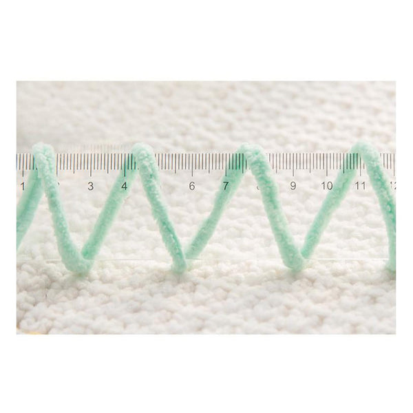 Green textured strip with a ruler on a white background