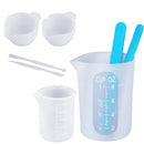 Set of silicone measuring cups and spoons with blue measurement markings on a white background